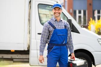 
Ein Handwerker steht vor einem Handwerksfahrzeug